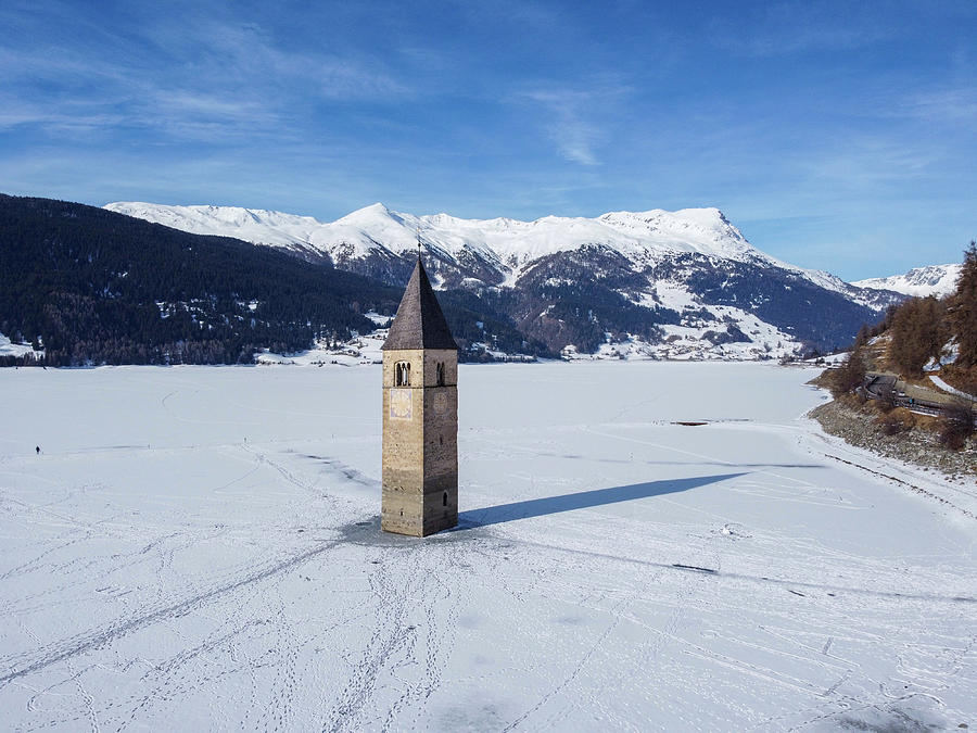 Il campanile sommerso del lago di Resia con la neve Photograph by Pietro Ebner