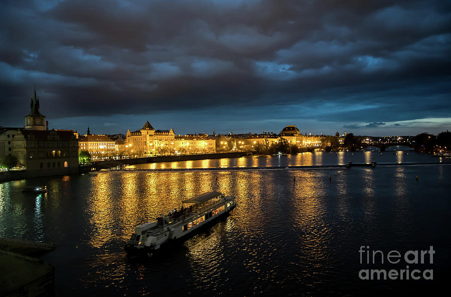 Illuminated Moldova River With Ship And Buildings In The Night In Prague In The Czech Republic Photograph by Andreas Berthold