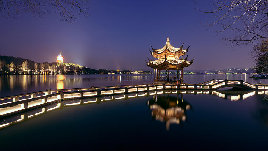 Illuminated pavilion against the Leifeng pagoda by the West Lake,Hangzhou,China Photograph by Xia Yuan
