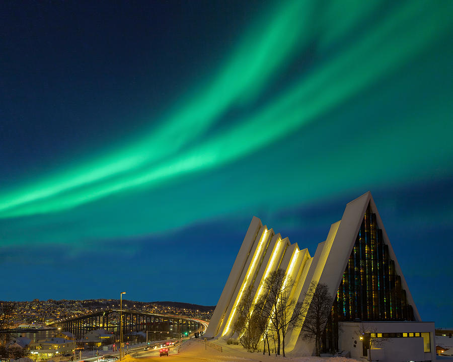 Illuminated Tromso cathedral at night with beautiful green shapes of aurora borealis Photograph by RelaxFoto.de