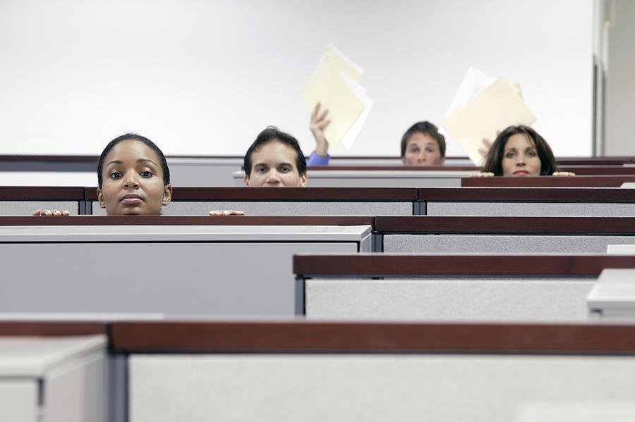 Impatient office workers looking over cubicle walls Photograph by Comstock Images