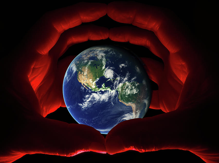 In Our Hands - Earth viewed from space grasped within globed hands Photograph by Peter Herman