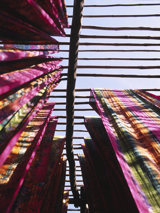 India, Gujarat, dyed fabrics drying on rack, low angle view Photograph by Michael Crockett Photography