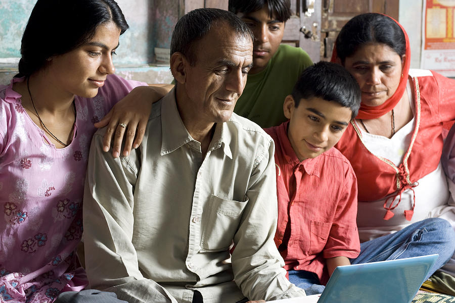 Indian Family Using Laptop at Home. Photograph by Pixelfusion3d
