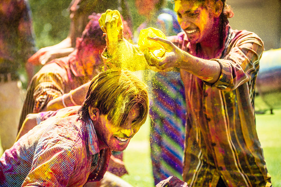 Indian friends throwing Holi Colorful Powder at each other Photograph by Ferrantraite