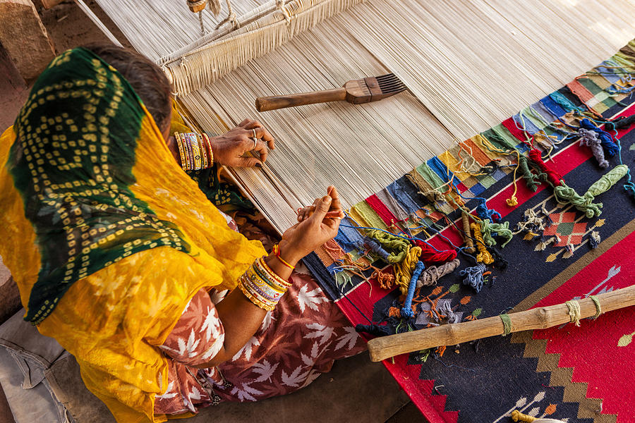 Indian woman making dhurry - colorful carpet Photograph by Bartosz Hadyniak