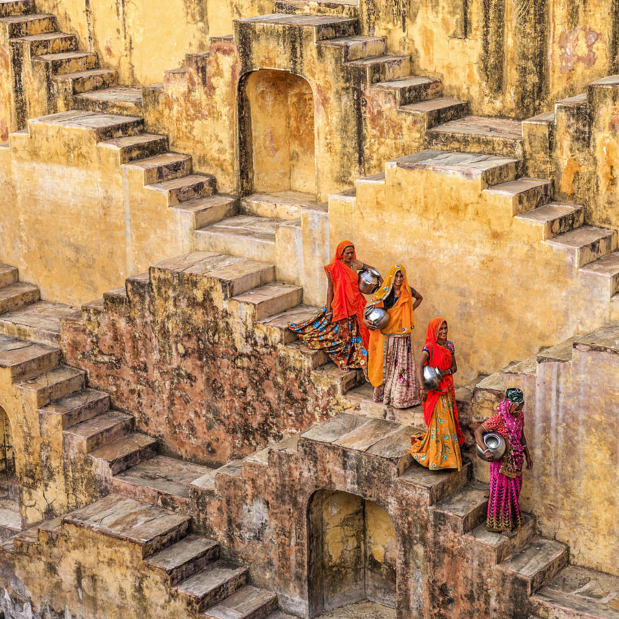 Indian women carrying water from stepwell near Jaipur Photograph by Bartosz Hadyniak