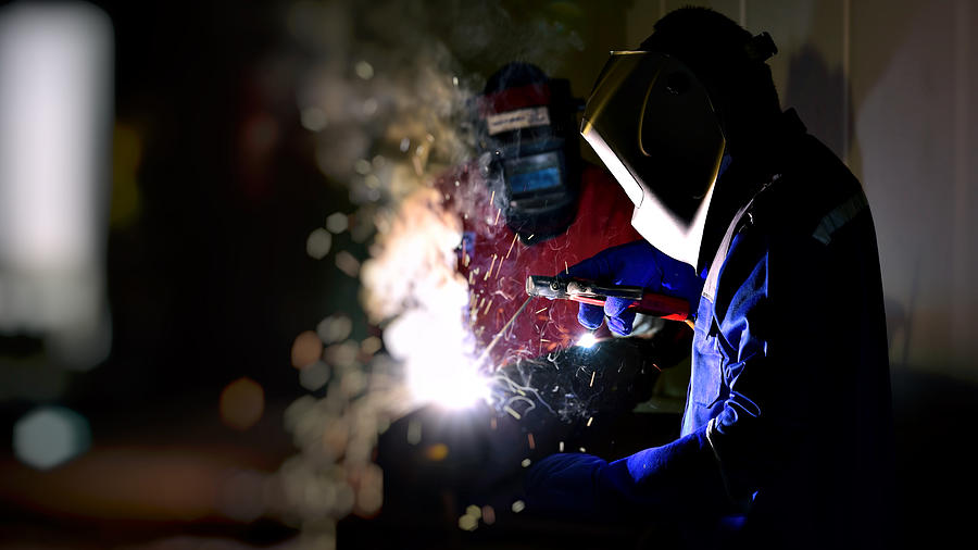 Industrial Worker at the factory welding close up . Photograph by Sarote Pruksachat