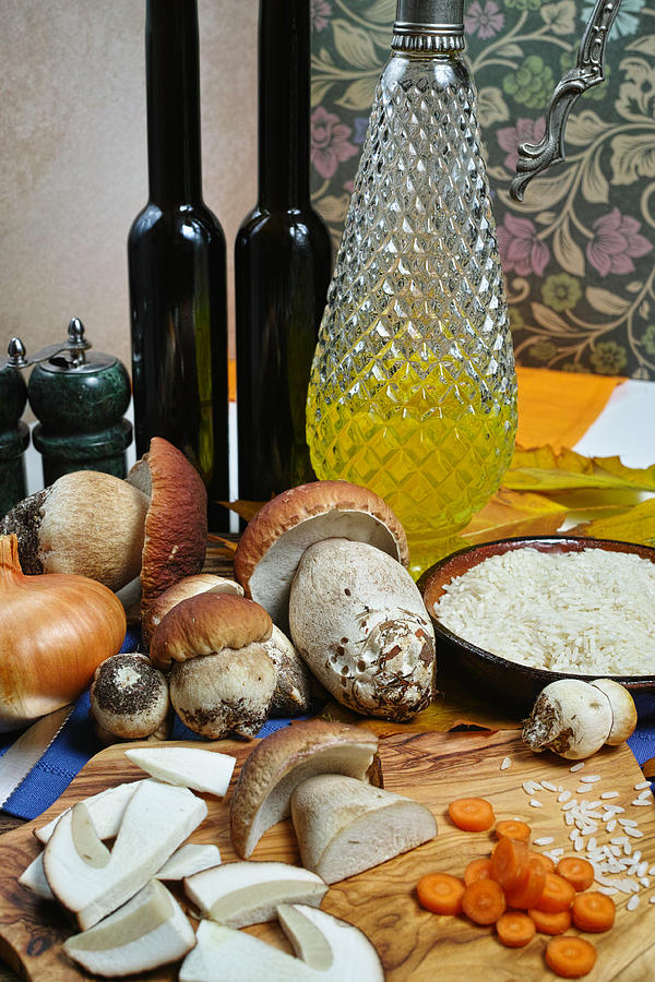 Ingredients for risotto with wild mushrooms boletus Photograph by Barmalini