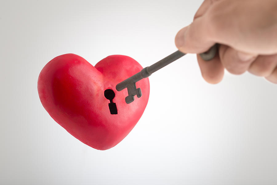 Inserting key to he heart shape object Photograph by Toshiro Shimada