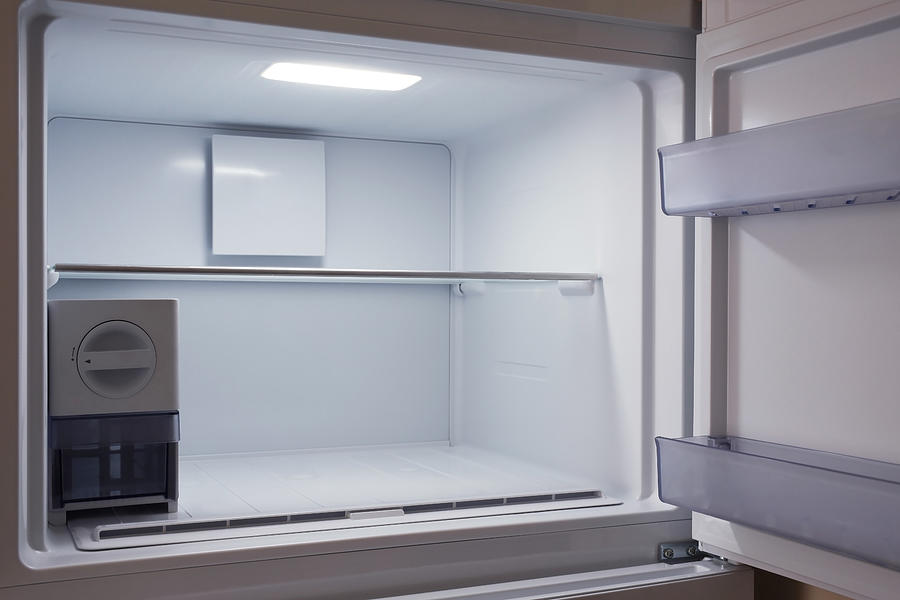 Inside of empty and clean modern refrigerator, freezer Photograph by Worldofstock
