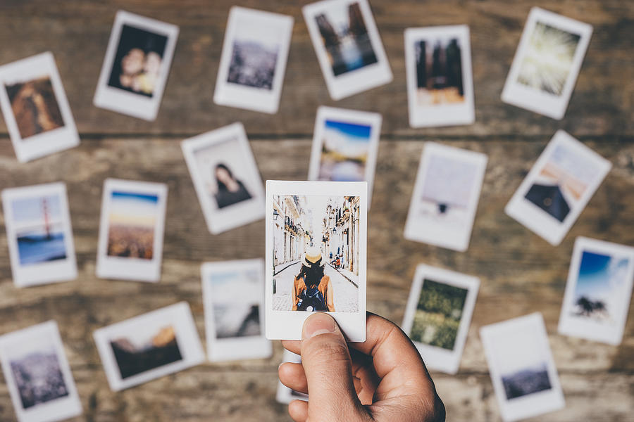 Instant camera prints on a table Photograph by FilippoBacci