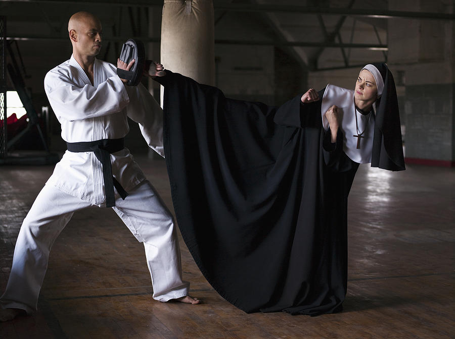 Instructor teaching martial arts to young nun Photograph by Martin San