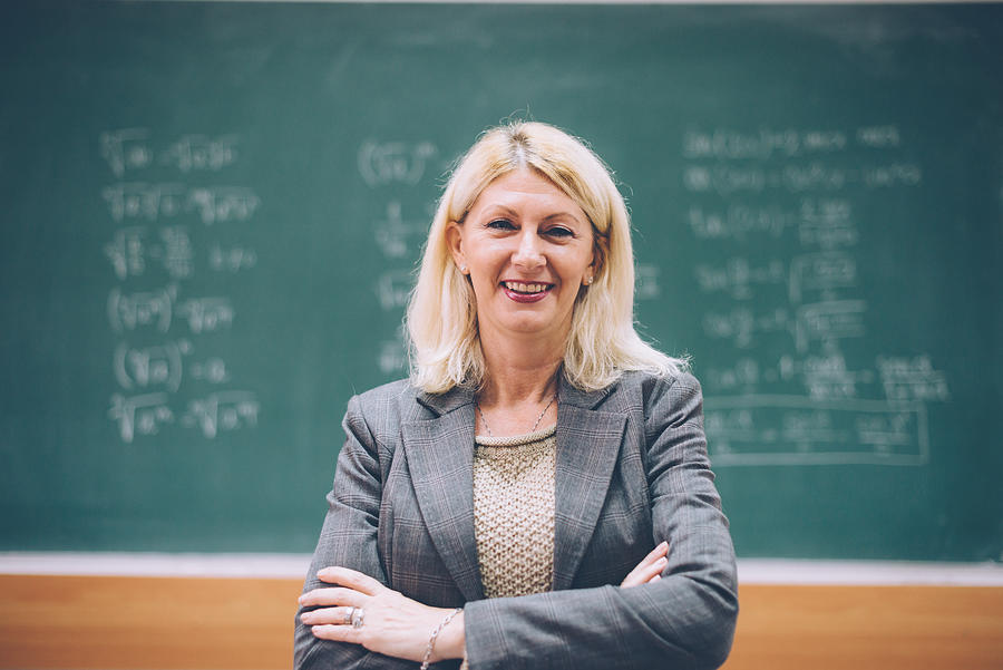 Intelligent matur female math professor in classroom Photograph by Drazen Lovric
