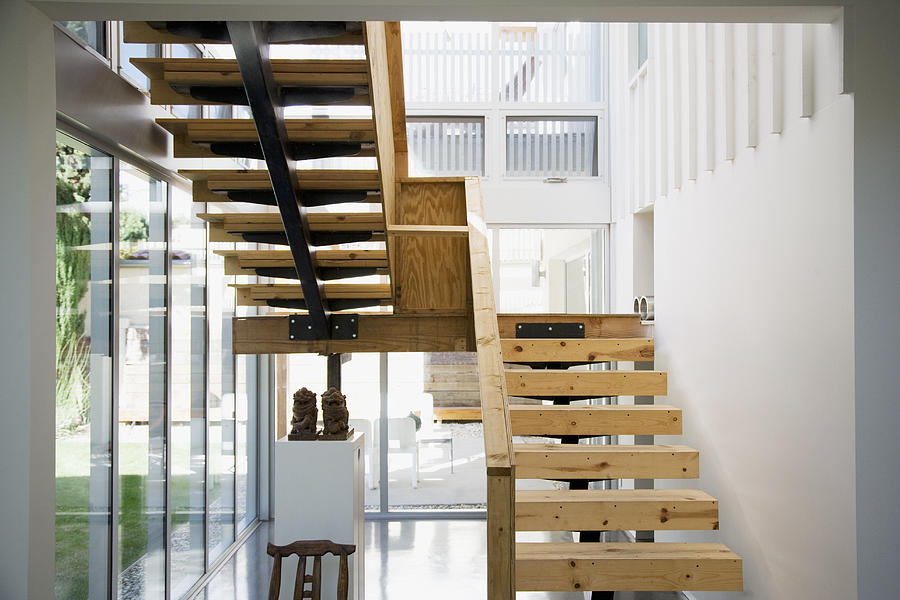 Interior of modern house, wooden stairway Photograph by Tom Merton