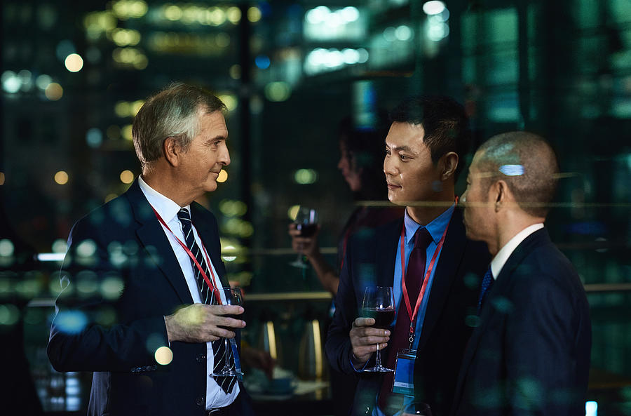 International businessmen at evening social event in the city Photograph by 10000 Hours