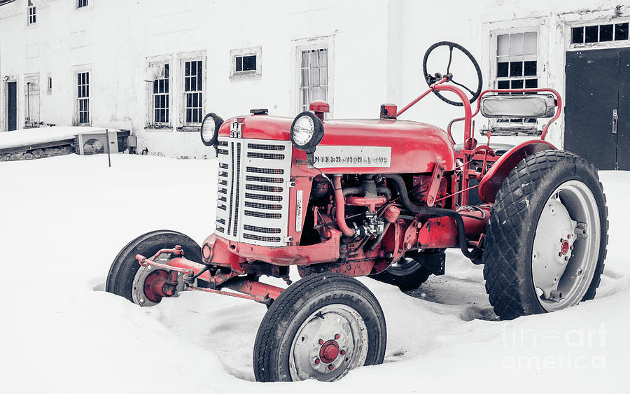 International Harvester Cub Red Tractor in the Snow Photograph by Edward Fielding
