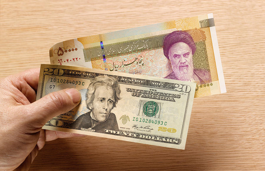 Iranian and US bank notes Photograph by Peter Dazeley
