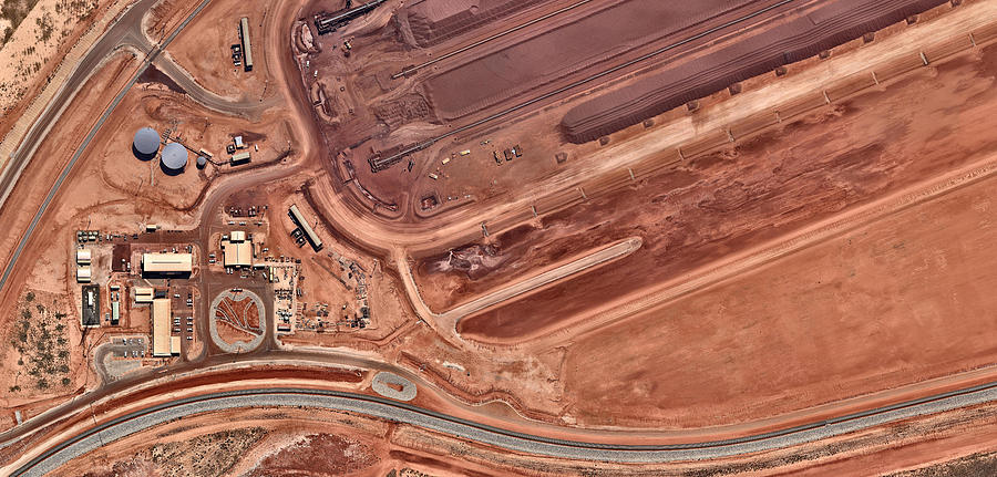 Iron ore facility with heavy machinery Photograph by Nearmap