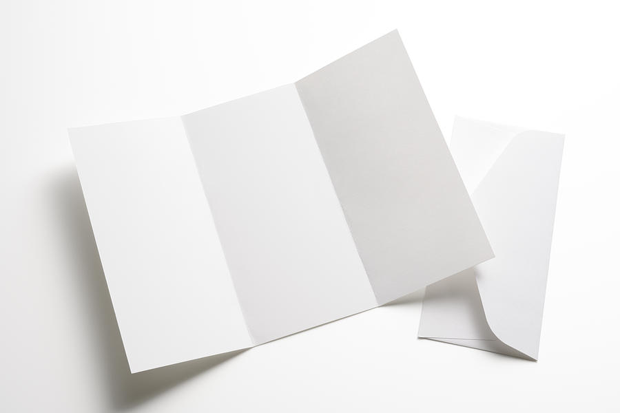 Isolated shot of blank booklet with envelope on white background Photograph by Kyoshino