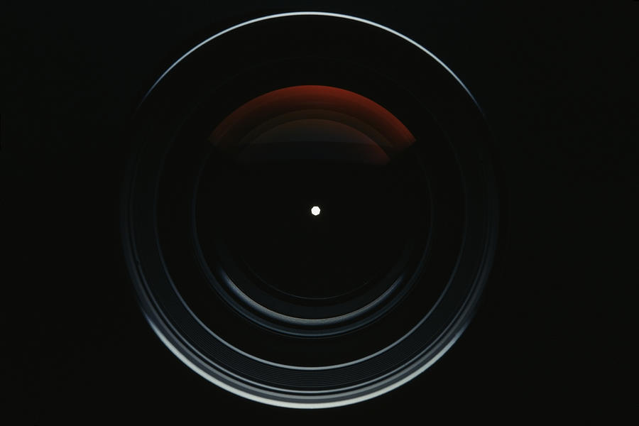 Isolated shot of professional camera lens against black background Photograph by Kyoshino