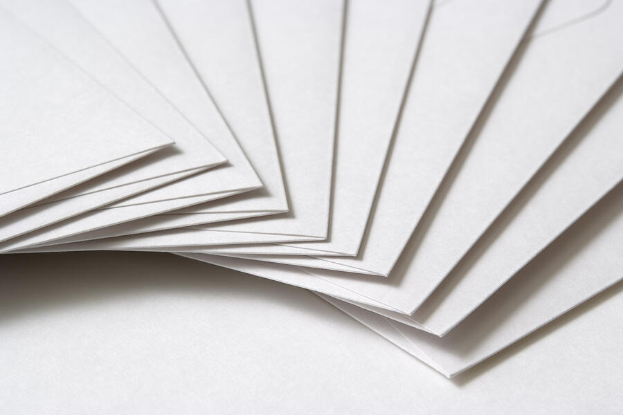 Isolated shot of stacked blank envelopes on white background Photograph by Kyoshino