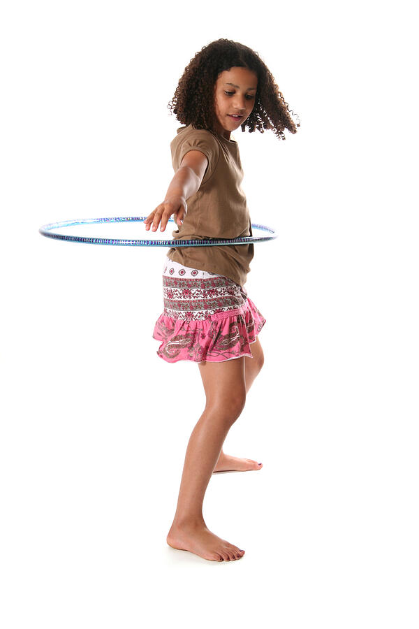 Isolated tween girl hula hooping on white background Photograph by Princessdlaf