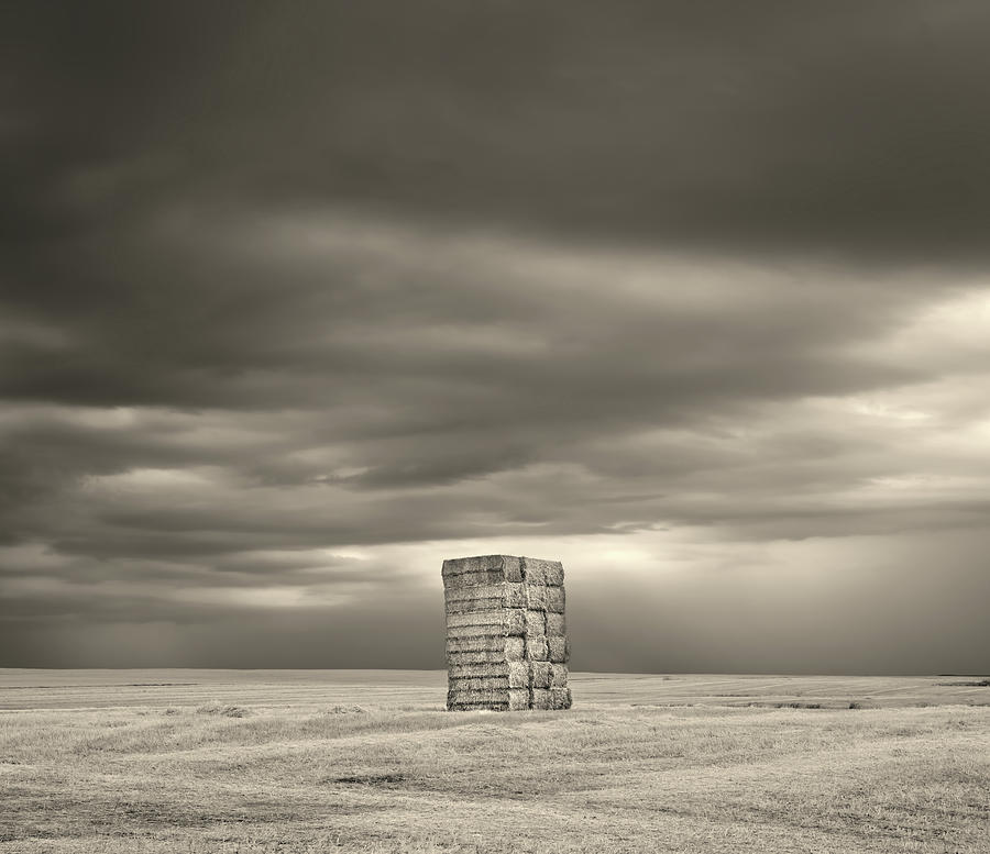 Isolation - Rectangular haybale monolith on a wheat field of ND prairie ver 2 of 2 Photograph by Peter Herman