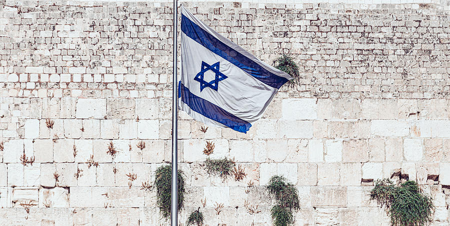 Israeli flag against Western Wall in Old City of Jerusalem Photograph by Kolderal
