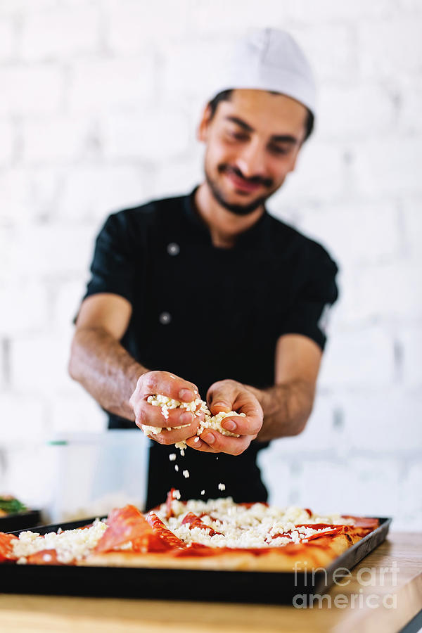 Italian chef pizzaiolo putting mozzarella cheese on pizza Photograph by ...