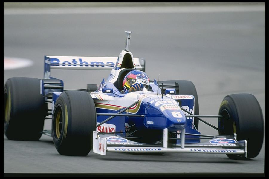 Jacque Villeneuve of Canada and the Williams Renault Team closes in on Damon Hill Photograph by Pascal Rondeau
