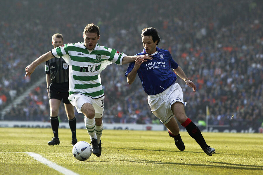 Jamie Smith of Celtic skips past Jerome Bonnissel of Rangers Photograph by David Cannon