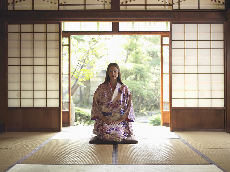 Japan, Tokyo, young woman in kimono kneeling on tatami mat, portrait Photograph by Michael H