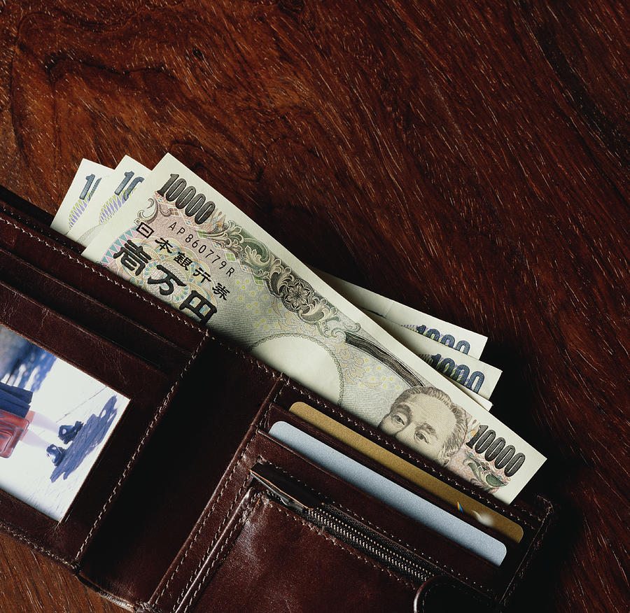 Japanese currency in wallet Photograph by Peter Dazeley