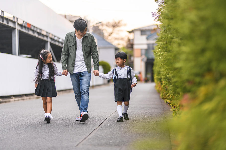 Japanese Father Walking With Elementary Age Schoolchildren Photograph by AzmanL