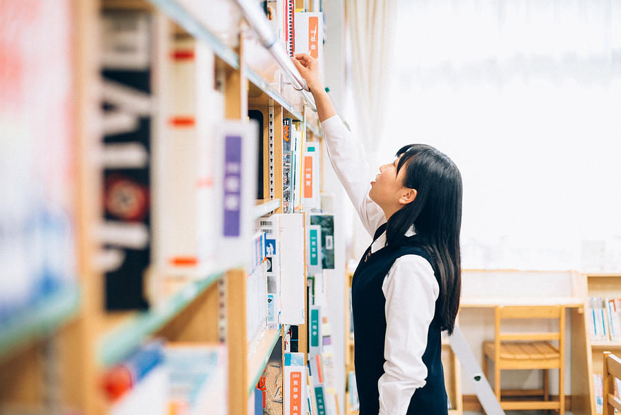 Japanese Female Student Reading in the Library Photograph by Ferrantraite