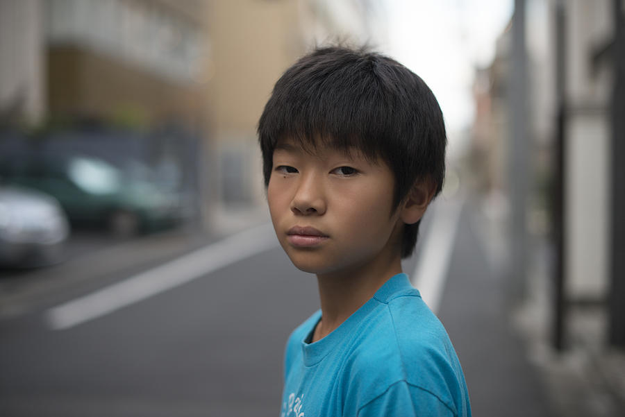 Japanese kid on the street looking at the camera Photograph by Shuji Kobayashi