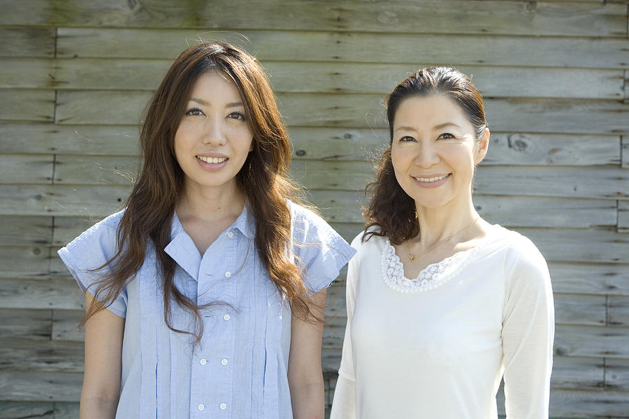 Japanese mother and daughter smiling, portrait Photograph by Indeed