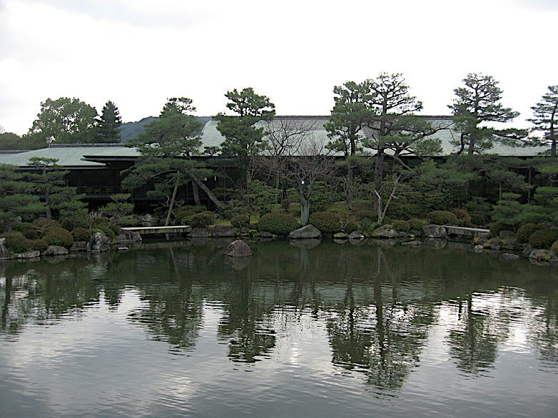 Japanese Temple with Reflections in the Water Photograph by Susan Grunin