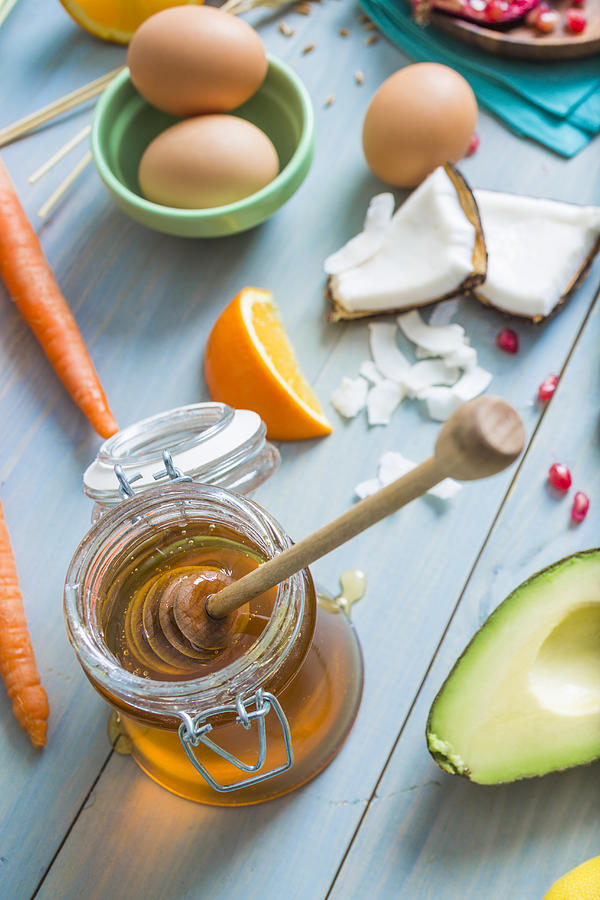 Jar of honey with dipper and fresh ingredients Photograph by Mike Kemp