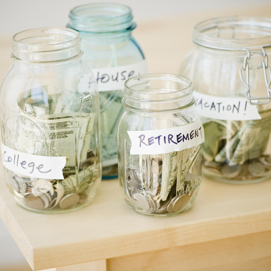 Jars of savings Photograph by Jamie Grill