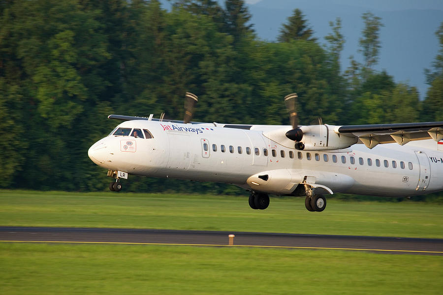 Jat Airways aircraft landing at Ljubljana Joze Pucnik Airport Photograph by Ian Middleton
