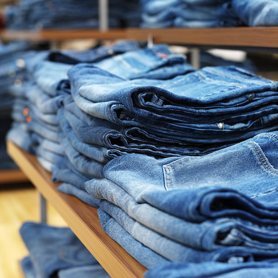Jeans On Shelves In A Clothing Store Photograph by Ciaran Griffin