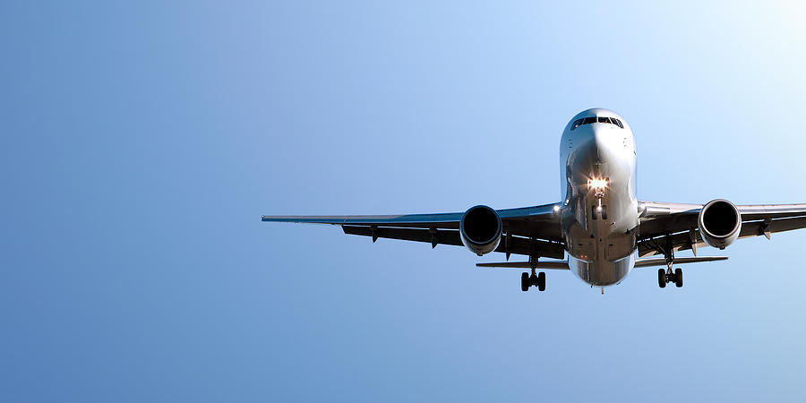 Jet Airplane Landing In Blue Sky Photograph by Sharply_done