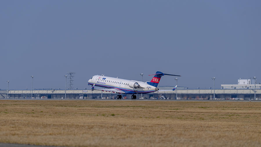 Jet airplane taking off from the Centrair Airport Photograph by Masaru123
