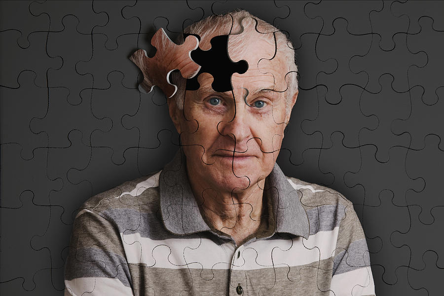 Jigsaw puzzle, of senior man, falling apart Photograph by Andrew Bret Wallis