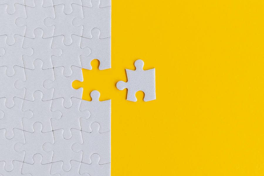 Jigsaw Puzzle on Yellow Background Photograph by Nora Carol Photography