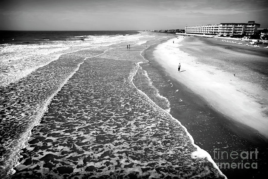 Jogging at Folly Beach in South Carolina Photograph by John Rizzuto