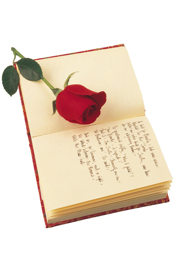 Journal with poetry and red rose Photograph by Comstock