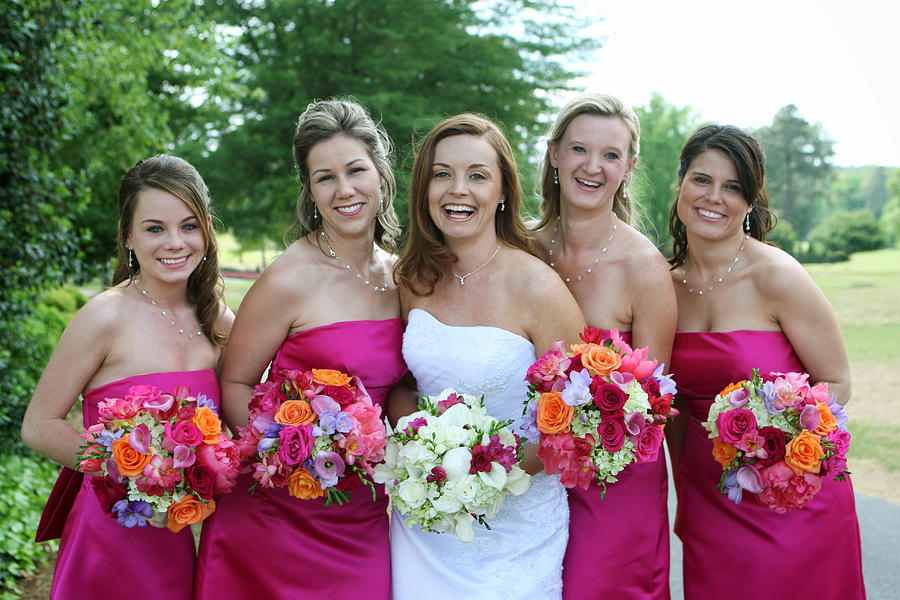 Joyous pink clad bridesmaids surround the bride Photograph by Kirin_photo